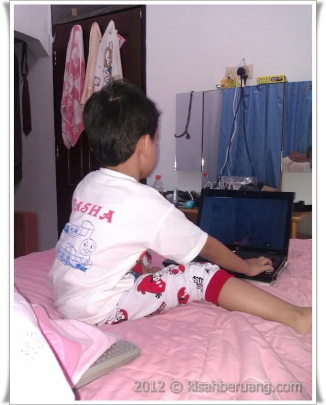 Engrossed Pasha engrossed in the computer game